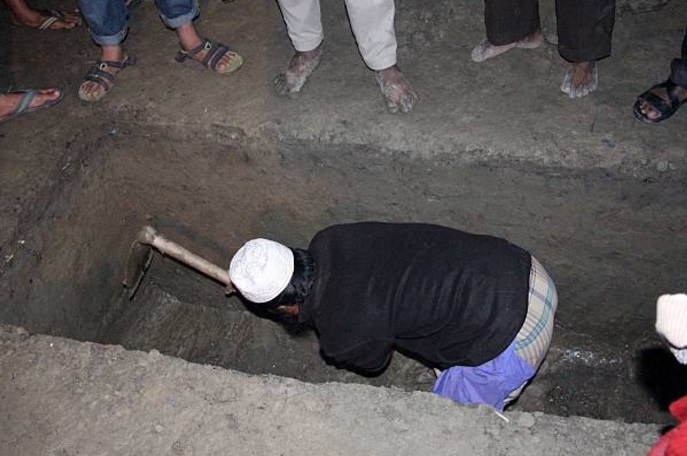 Un hombre cava una tumba durante una ceremonia de entierro en India (Getty Images/archivo)