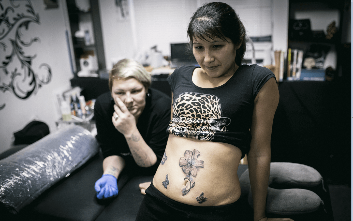 Una mujer en Rusia muestra un tatuaje que cubre una cicatriz originada por un acto de violencia. (AP)