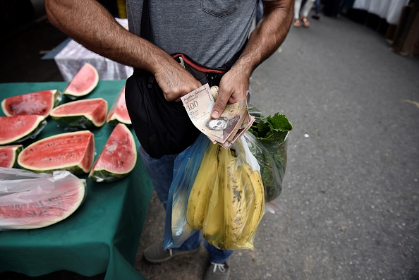 Un hombre realiza un pago por comida en un mercado de Caracas, Venezuela (Getty Images, archivo)