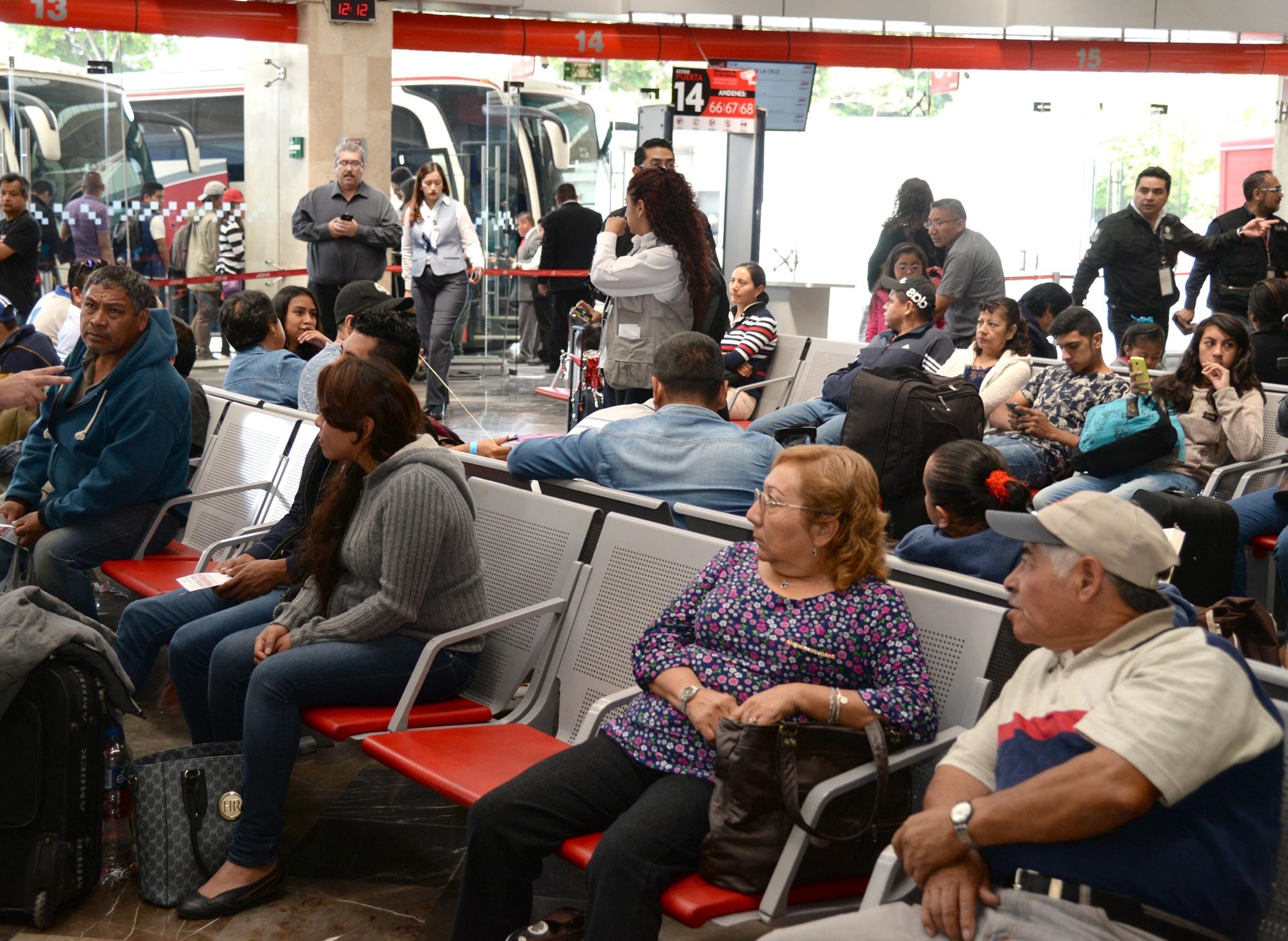 Pasajeros esperan para abordar autobús en terminal de pasajeros (NTX)