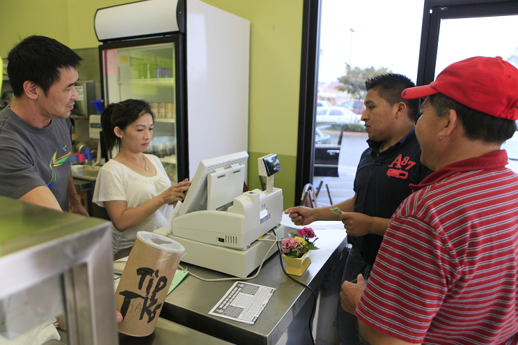 Dos hispanos realizan compras en una tienda de California