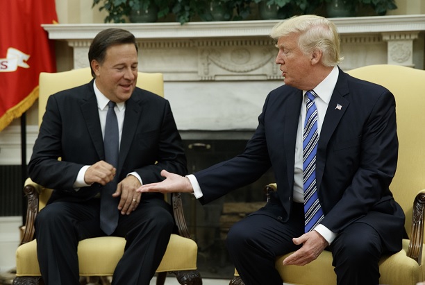 Donald Trump intenta estrechar la mano de su homólogo de Panamá, Juan Carlos Varela, en la Oficina Oval en la Casa Blanca (AP)