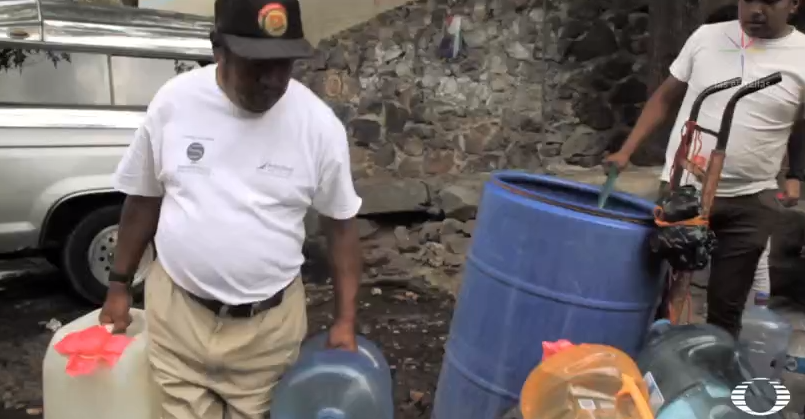 Vecinos Xochimilco acarrean botellones con agua a un mes del sismo 19S