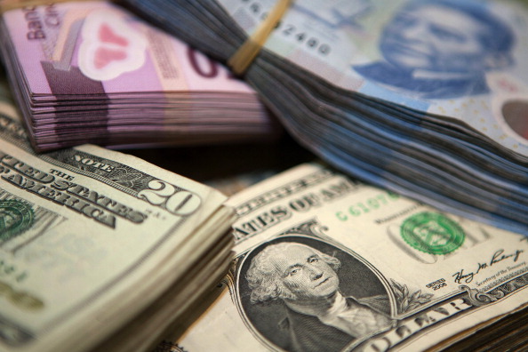 Dólares y pesos, en billetes, reunidos en fajos