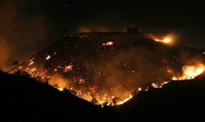 LOS ANGELES, CA - DECEMBER 05: The Creek Fire burns on a hillside in the Shadow Hills neighborhood on December 5, 2017 in Los Angeles, California. Strong Santa Ana winds are rapidly pushing multiple wildfires across the region, expanding across tens of thousands of acres and destroying hundreds of homes and structures. (Photo by Mario Tama/Getty Images)