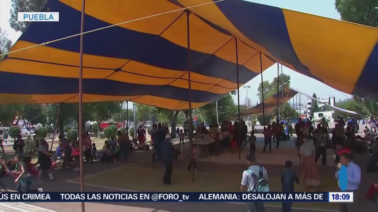 Migrantes permanecen en campamento en Puebla