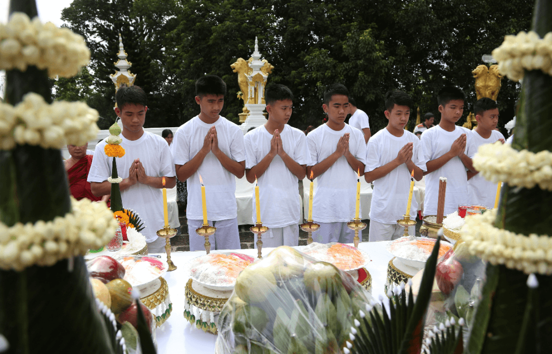 Niños tailandeses y entrenador en ceremonia budista. (AP)