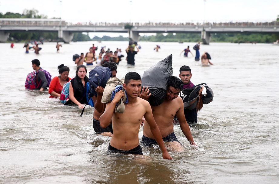 Centenares de migrantes hondureños cruzan río que separa Guatemala y México