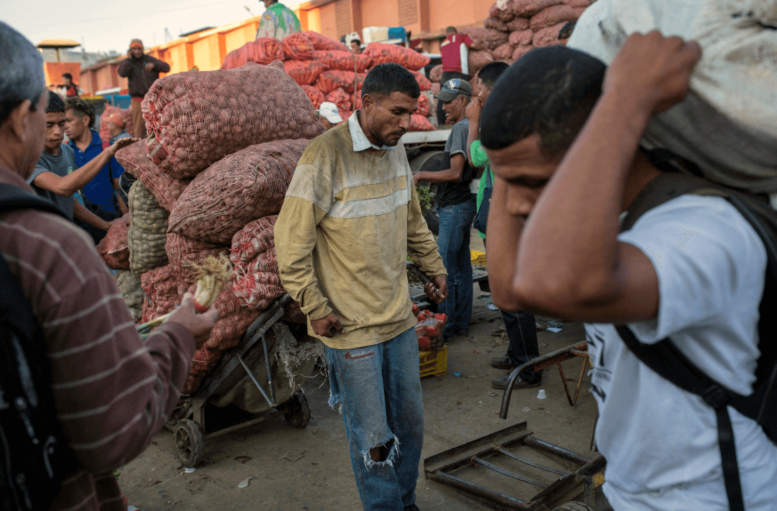Foto: Hombre transporta verduras en mercado de Venezuela, 28 de enero 2019, Caracas, Venezuela