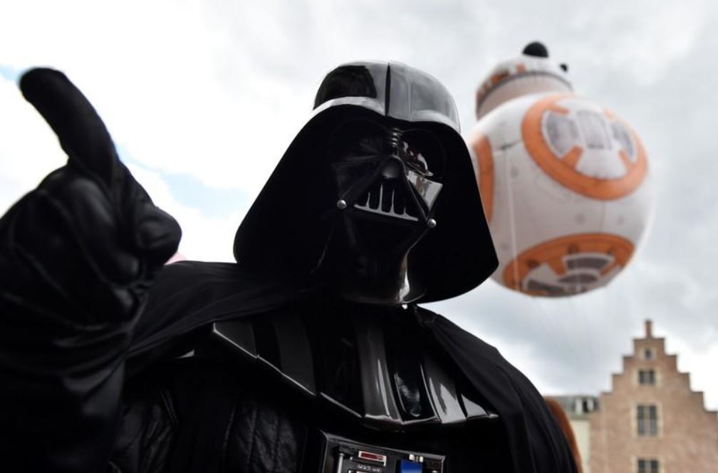 Imagen: Un globo de BB-8 flota detrás de una persona usando un traje de Darth Vader durante el Balloon Day Parade, Bruselas, Bélgica, el 27 de abril de 2019 (Reuters, archivo)