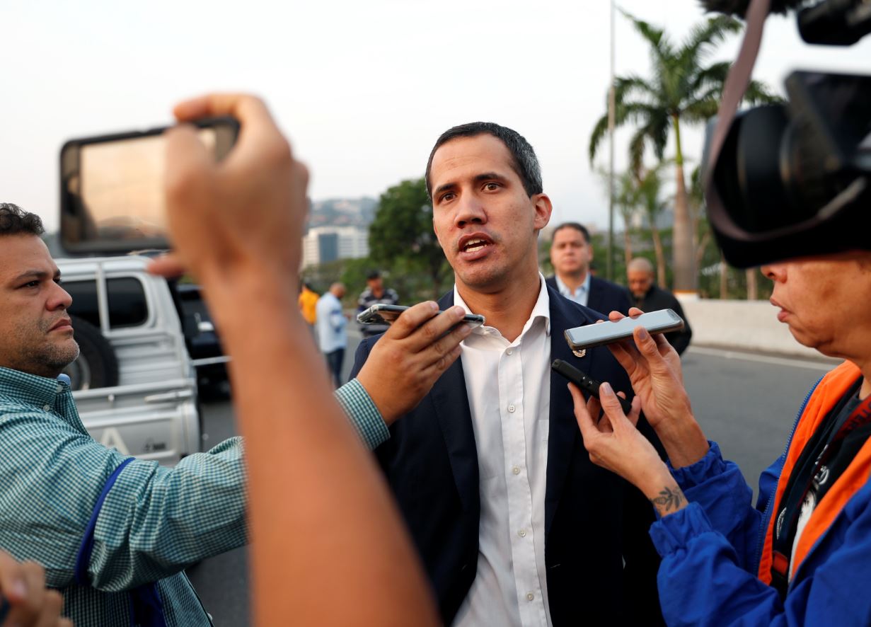 El líder opositor y presidente autoproclamado Juan Guaidó habla con medios de comunicación cerca de la base aérea militar 'La Carlota' en Caracas (Reuters)