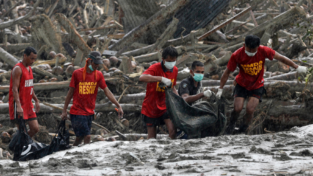 Foto: Rescatistas recuperan los cuerpos de las víctimas por las inundaciones provocadas por el tifón ‘Bopha’, 7 diciembre 2012