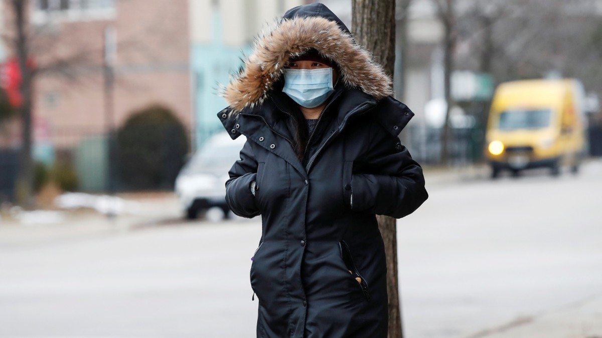 Foto: Una mujer camina por las calles usando un cubreboca. Reuters