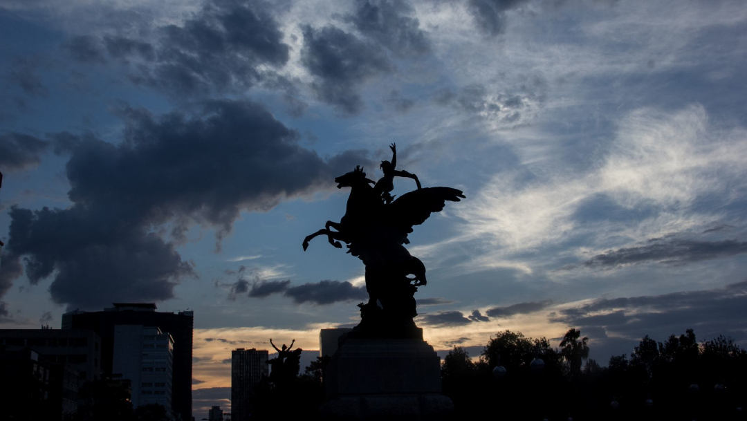 Fotografía que muestra un cielo semi nublado detrás de la silueta de uno de los pegasos que custodian el Palacio de Bellas Artes. (Foto: Cuartoscuro)