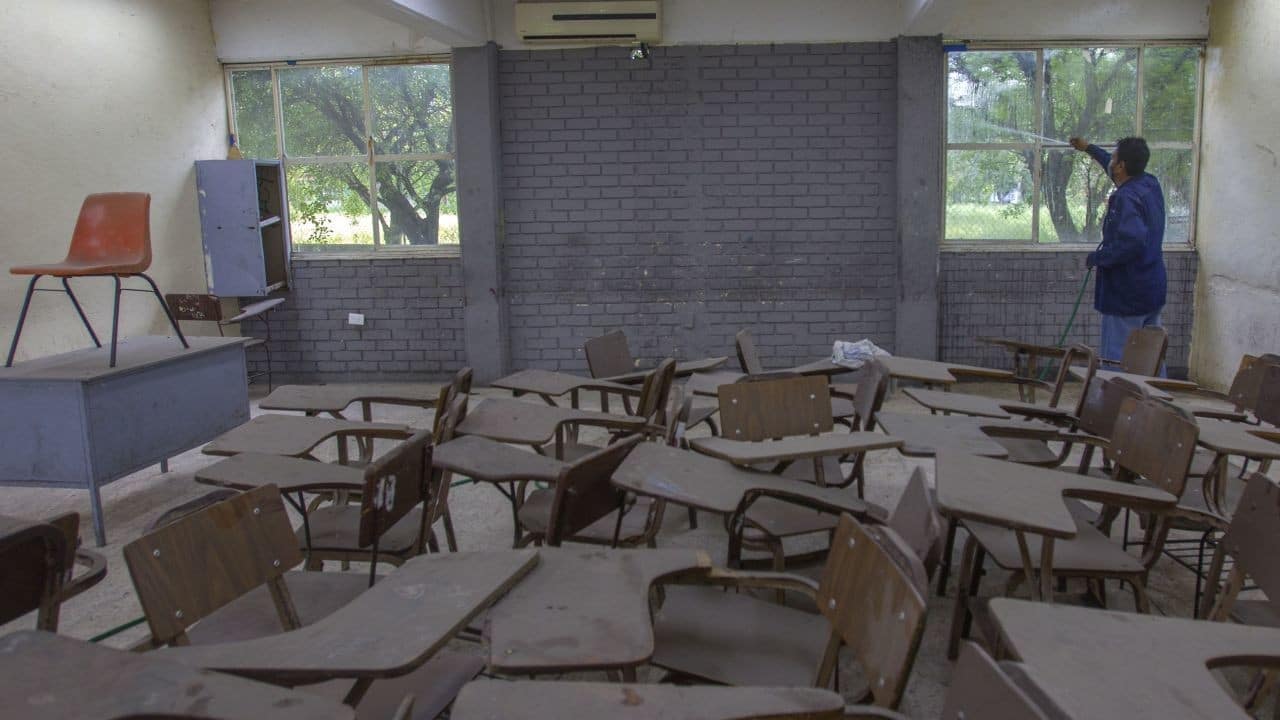 Personal educativo realiza labores de limpieza en un aula de una escuela secundaria (Cuartoscuro)