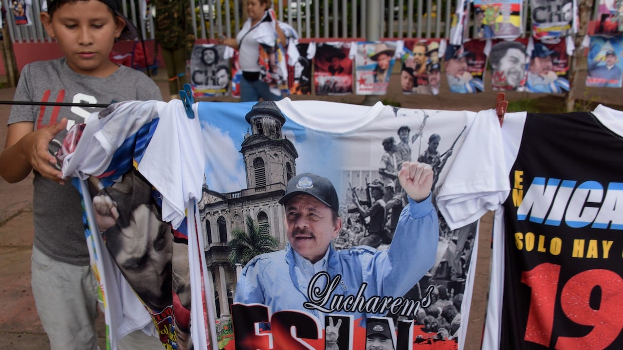 Un niño cuelga camisetas con fotos del presidente nicaragüense Daniel Ortega (Getty Images)