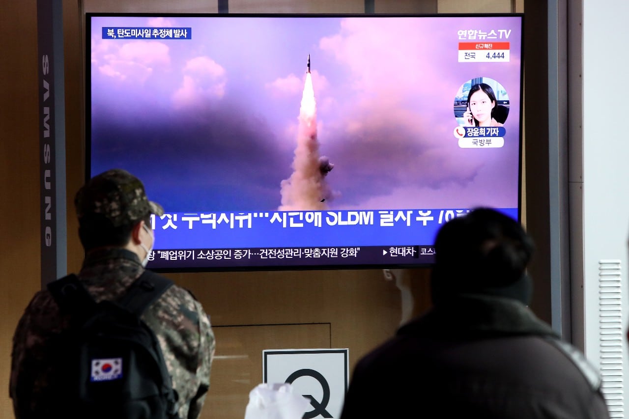 La gente ve un televisor en la estación de tren de Seúl que muestra una imagen de archivo del lanzamiento de un misil norcoreano, el 5 de enero de 2022 (Getty Images)
