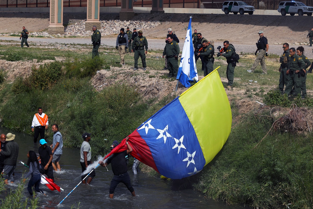 Agentes de la Patrulla Fronteriza de El Paso disparan balas de goma a un grupo de migrantes venezolanos que cruzan el Río Bravo, 31 de octubre 2022 (AFP)